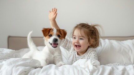 A little kid and a puppy dog in bed at home