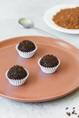 Brigadeiro - traditional Brazilian sweet made from condensed milk, cocoa powder, butter and...