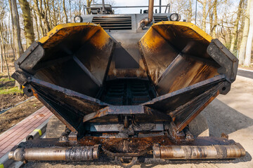 Asphalt paver filled tarmac laying new road building construction site 