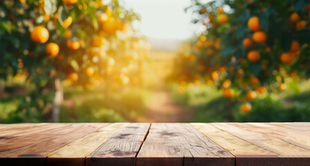 Wood table top with blur of orange garden in the morning.For montage product display or design key...