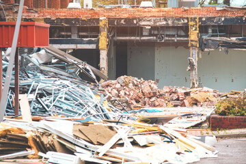 Dismantling  old building, pile of rubble at demolishing site