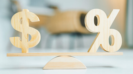 Wooden dollar model, Percentage symbol on wooden balance with sunlight, Concepts of interest, a...