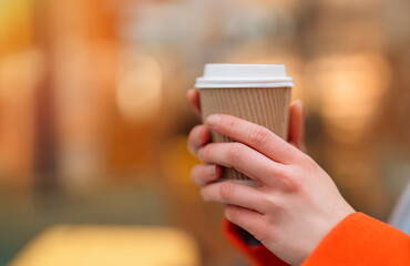 hand of woman holding craft cup of coffee at  side cafe outside  