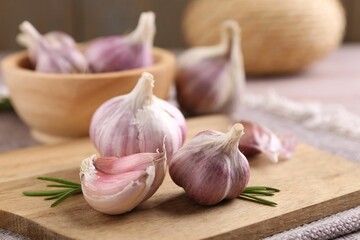 Bulbs and cloves of fresh garlic on table, closeup