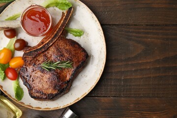 Tasty grilled meat, rosemary, tomatoes and marinade on wooden table, top view. Space for text