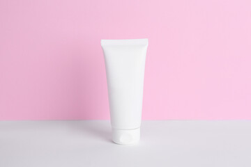 Tube of cream on color background. Body care product