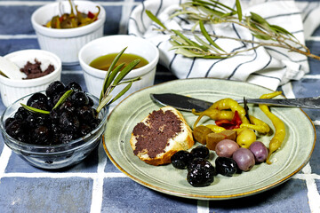 Tapenade - paste made from olives. Bowls with spreadable black and green olive cream and oil on...
