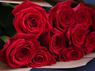 A beautiful bouquet of red roses in paper wrapping. Close-up