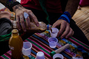 Sao Paulo, SP, Brazil - December 16 2023: Person serving doses of Ayahuasca details.