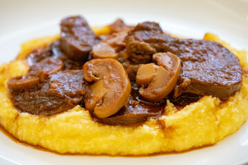 Traditional beef tongue in Madeira sauce with polenta. Brazilian rustic dish
