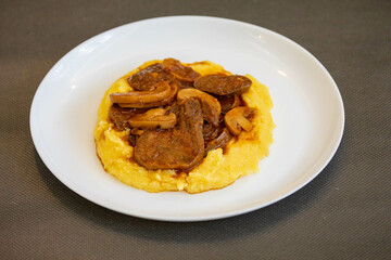 Traditional beef tongue in Madeira sauce with polenta. Brazilian rustic dish