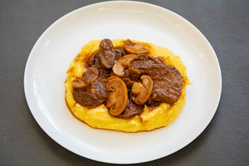Traditional beef tongue in Madeira sauce with polenta. Brazilian rustic dish
