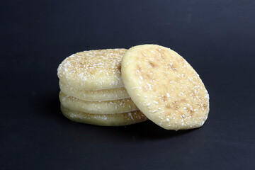 Sugar coated sponge cake with sugar top on black background.