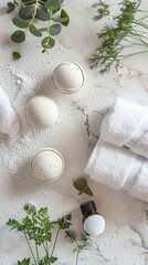 Top-view shot of a spa setting on a natural stone surface: bath bombs, rolled towels, essential oil dropper, and sprigs of green herbs