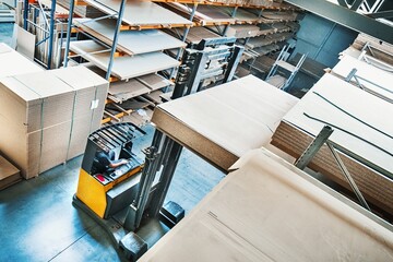 Efficient Warehouse Operations: Electric Forklift Handling Plywood Panels in 4K image (Horizontally...