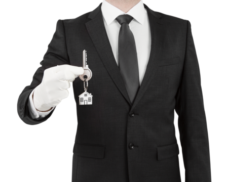 A person in a suit holding a keychain with a house symbol, pictured without a head, against a white background, symbolizing property ownership