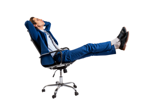 A man in a blue suit relaxing in an office chair, isolated on a white background, representing the concept of leisure or break time at work
