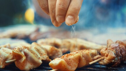 Sizzling BBQ: Closeup of Unrecognizable Person Flipping Meat and Sausages on Grill, Ready for...