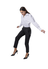 A woman in business attire stepping down against a white background, displaying professional modern fashion