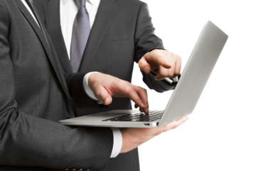 A businessman typing on a laptop isolated against a white background, depicting the concept of business technology
