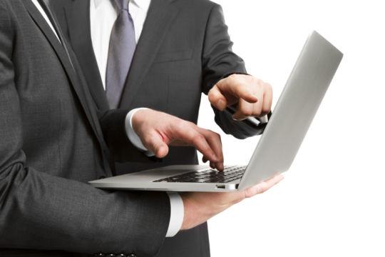 A businessman typing on a laptop isolated against a white background, depicting the concept of business technology