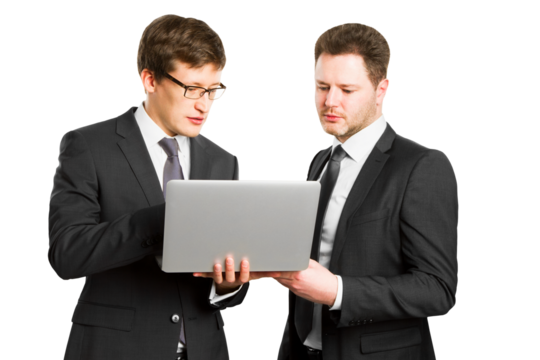 Two men in business suits reviewing a laptop together against a white background, concept of teamwork