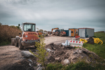 there is a large excavator and containers on a large building site