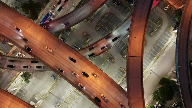 Aerial top down view of cars driving on Downtown I95 Riverside multilane highway at night, transport infrastructure in Miami. Drone flight over multi-level intersection Miami Florida