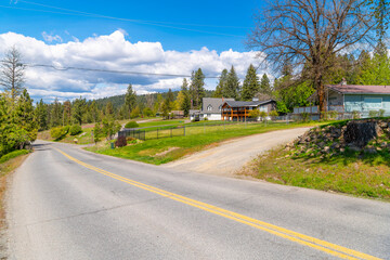 A curving hillside street of ranch homes in a rural mountain section of downtown Coeur d'Alene,...