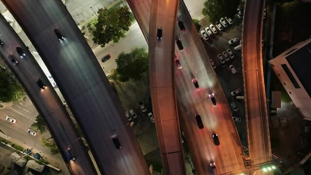 Aerial top down view of carsvehicles driving on Downtown I95 Riverside multilane highway at night, transport infrastructure in Miami. Drone flight over multi-level intersection Miami Florida