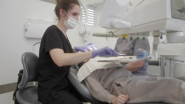 Dental treatment for caries. After placing the filling, the pediatric dentist performed a bite test using shim stock to identify areas that required occlusal adjustment.