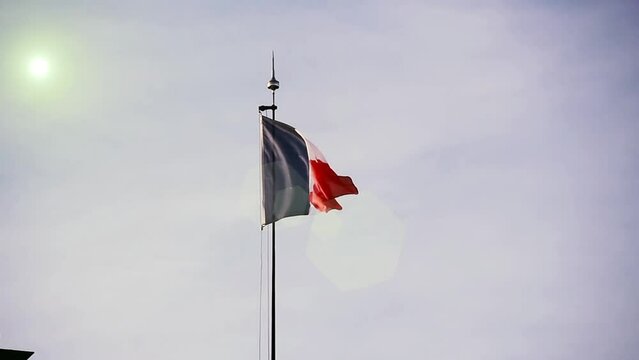A Flag of France Waving Against the Sky in Paris.