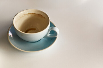 an empty dirty coffee cup. on the table