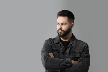Fototapeta premium Portrait of young man with mustache on grey background. Space for text