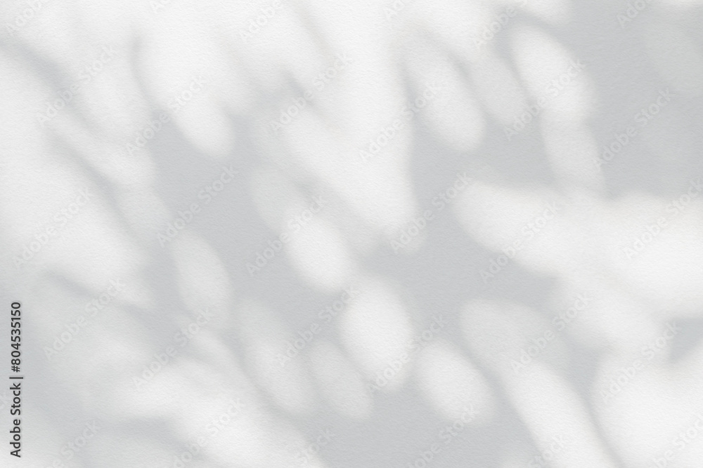 Aufkleber Tree shadow and leaf branch with light bokeh background. Nature leaves tropical jungle light and dark shadow dappled on white concrete wall texture for background wallpaper, overlay effect and design