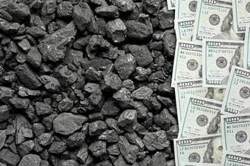 Dollar banknotes on pieces of coal, top view. Resource price