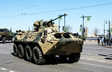 An armored personnel carrier BTR-82AM, against the backdrop of the Peter and Paul Fortress, goes to...