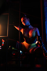 Beautiful go-go dancer poses in a nightclub. atmospheric light. Party concept, nightclub