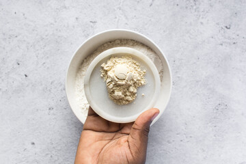Overhead view of vital wheat gluten in a marble tray, vital heat gluten for making bread