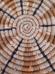 Center of wicker basket background. Native indigenous basket weaving detail. Fragment of a round...