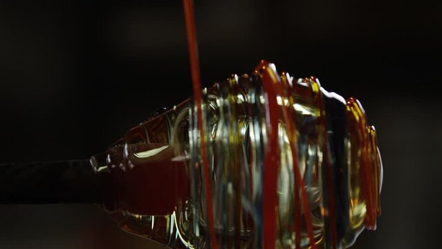 Molten glass is dibbled over a bulb of glass for decoration