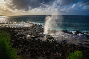2023-12-31 THE BEAUTIFUL SPOUTING HORN SPRATING WATER INTHE AIR WITH A BEAUTIFUL SKY AND SUNSET WITH A REFLECTION OFF OFTHE ROCKS ON KAUAI HAWAII