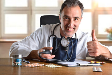 Doctor with tensiometer and hand with ok gesture in office - obrazy, fototapety, plakaty