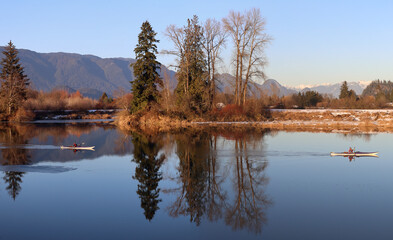 Kayaking tranquil waters in winter scenery
