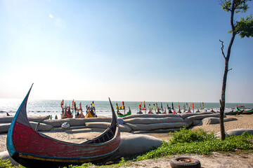 Traditional Wooden Fishermen's fishing boat, Inani Beach, Coxs bazar, Bangladesh. Colorful Wooden Fishing Boat On a Cox's Bazar Sea Beach With Blue Sky Background in Bangladesh.