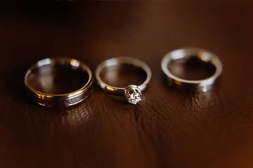 white gold wedding rings on a leather background. Wedding ring.