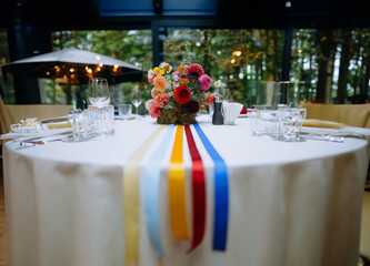 venue for a wedding reception with decor, selective focus on tables and decor. bright decor on the...