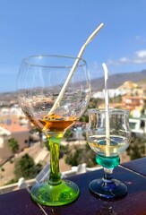 Set of coloured glasses at the restaurant with wines and. beer - concept. of celebration and catering work - defocused background with barEmpty cocktail glasses after a fun birthday party with friends