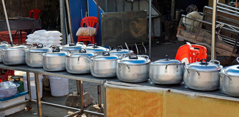 steet kitchen with many pots