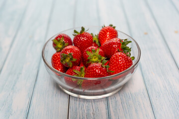 Red ripe strawberry background, close-up, front view, top view, strawberry plate with wood floor background,